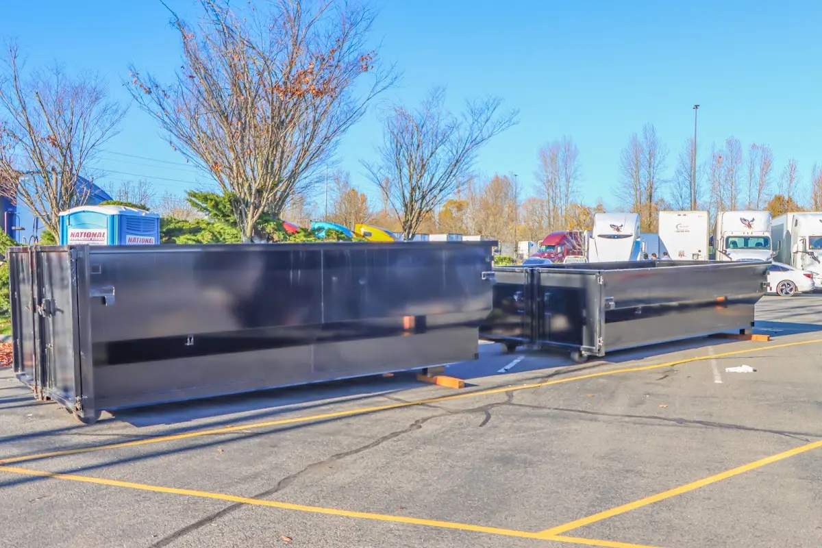 Professional dumpster rental service with roll-off container on residential driveway in Winterville